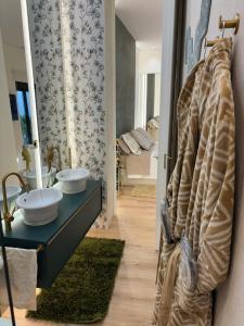 a bathroom with two sinks and a mirror at El Balcón del Mercado Chico in Avila +22 photos