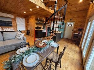 a dining room and living room with a table and chairs at SkyView treehouse in Belgrade
