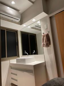 a bathroom with a sink and a mirror at Ocean Flat 707 - Praia da Costa in Vila Velha