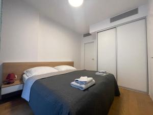 a bedroom with a bed with two towels on it at SAG Sky Park Residence Free parking and Wi-Fi in Bratislava
