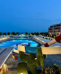 a swimming pool with a boat on the roof of a building at Apartment Premier Fort Beach hotel F1 420 in Sveti Vlas