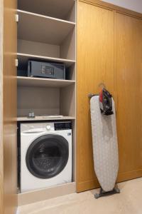 a washer and dryer in a room at Marriott Executive Apartments Istanbul Investvadi in Istanbul