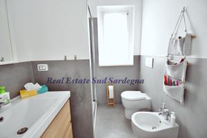 a bathroom with a white toilet and a sink at Villa Virginia in Sarroch +33 photos