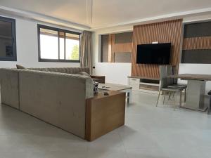 a living room with a couch and a table at Malabata Gandori Familia Tanger in Tangier