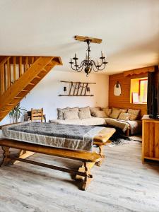 a living room with a bed and a couch at Duplex « les 7 Marmottes », Les Balcons de Recoin in Chamrousse