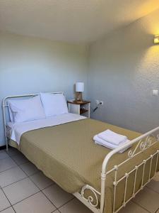 a bedroom with a bed with white pillows at Villa Diomedes in Sani Beach