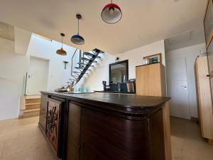 a large wooden bar in a room with a staircase at Villa la Caladine in a quiet location in Bormes-les-Mimosas