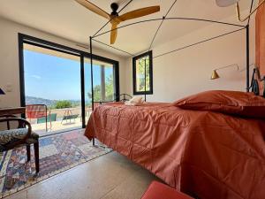 a bedroom with a bed and a large window at Villa la Caladine in a quiet location in Bormes-les-Mimosas +62 photos