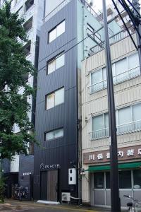 a building with a sign on the side of it at RShotel in Tokyo