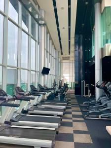 un gimnasio con filas de cintas de correr en un edificio en 辉煌象神庙主路地铁旁 全配套设施高端公寓 网红打卡地, en Bangkok