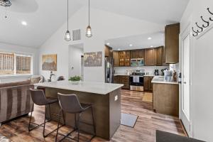 an open kitchen and living room with a large island at Nehalem Coastal Oasis - Secluded Coastal Home with Hot Tub on 14 Acres in Nehalem