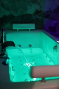 a ping pong table with a pool cue at Appart Hotel avec Sauna, Jacuzzi, in Strasbourg