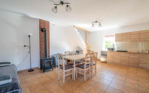 a kitchen and dining room with a table and chairs at Domki u Bogdana in Dąbki