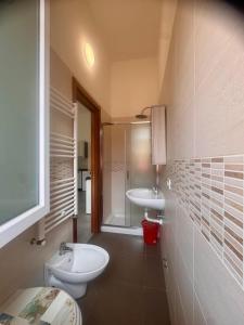 a bathroom with a white toilet and a sink at Sarno La Vecchia Cascina in Sarno