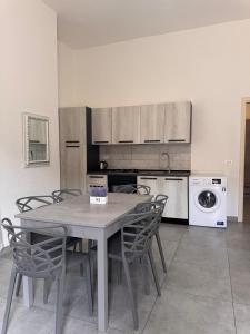 a kitchen with a table and chairs and a washing machine at Sarno La Vecchia Cascina in Sarno +41 photos