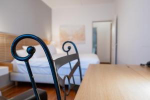 Cama ou camas em um quarto em Hotel Les Arcades