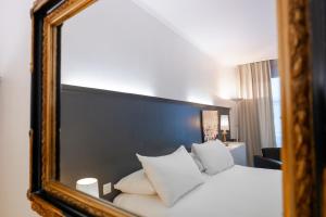 Cama ou camas em um quarto em Hotel Les Arcades