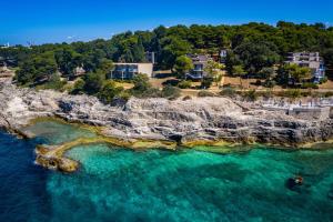 an aerial view of a beach with turquoise water at Arena Verudela Beach in Pula