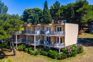 an aerial view of a house with balconies and trees at Arena Verudela Beach in Pula