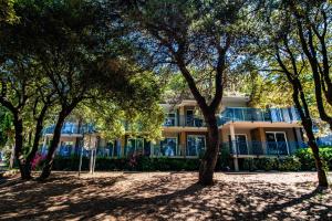 a building with trees in front of it at Arena Verudela Beach in Pula