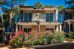 an apartment building with a balcony and flowers at Arena Verudela Beach in Pula