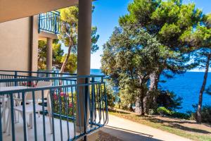 a balcony of a house with a view of the ocean at Arena Verudela Beach in Pula