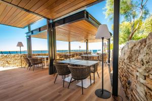 a patio with a table and chairs on a deck at Arena Verudela Beach in Pula +17 photos