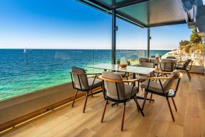 a dining room with a view of the ocean at Arena Verudela Beach in Pula