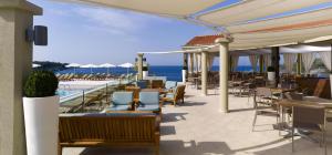 a restaurant with a view of the ocean at Arena Verudela Beach in Pula