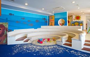 a childs play room with a large bed and blue walls at Arena Verudela Beach in Pula