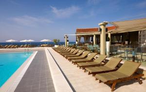 a swimming pool with lounge chairs and a resort at Arena Verudela Beach in Pula