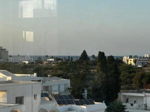 a view of a city with buildings and trees at Sea View 1 Bedroom Apartment with 100m Terrace in Sousse +1 photo