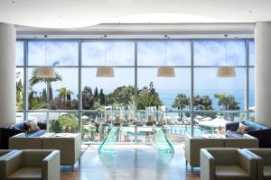 a hotel lobby with a view of the ocean at Mediterranean Beach Hotel in Limassol