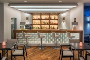 a restaurant with tables and chairs and a bar at Mediterranean Beach Hotel in Limassol