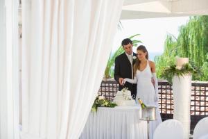 a bride and groom cutting their wedding cake at Mediterranean Beach Hotel in Limassol