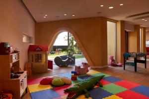 a childrens room with a play area with a play implement at Mediterranean Beach Hotel in Limassol