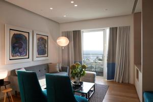 a living room with a couch and a table at Mediterranean Beach Hotel in Limassol