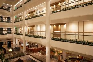an apartment building with balconies and a lobby at Mediterranean Beach Hotel in Limassol