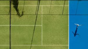a shadow of a person on a tennis court at Mediterranean Beach Hotel in Limassol