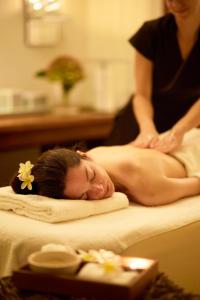 a woman getting a massage in a massage at Mediterranean Beach Hotel in Limassol