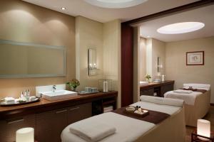 a bathroom with two beds and a sink at Mediterranean Beach Hotel in Limassol
