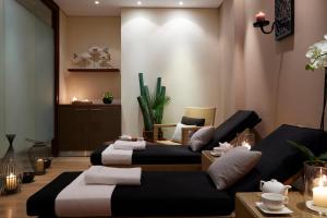 a living room with two beds and a couch at Mediterranean Beach Hotel in Limassol