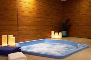 a jacuzzi tub with clouds in a room at Mediterranean Beach Hotel in Limassol