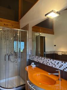 a bathroom with an orange sink and a shower at Casa Valsassina in Primaluna +32 photos