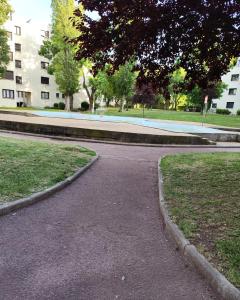 eine leere Straße in einem Park neben einem Gebäude in der Unterkunft Hébergement tout confort dans logement proche de la gare in Montpellier