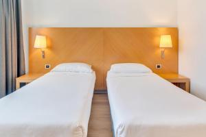 Postel nebo postele na pokoji v ubytování B&B HOTEL Bergamo Executive
