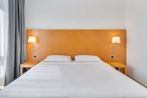 Postel nebo postele na pokoji v ubytování B&B HOTEL Bergamo Executive
