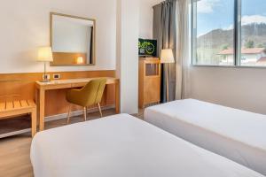 Postel nebo postele na pokoji v ubytování B&B HOTEL Bergamo Executive