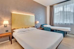 Postel nebo postele na pokoji v ubytování B&B HOTEL Bergamo Executive