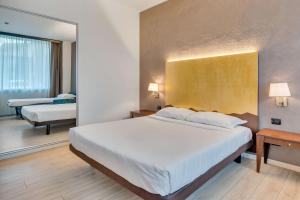 Postel nebo postele na pokoji v ubytování B&B HOTEL Bergamo Executive